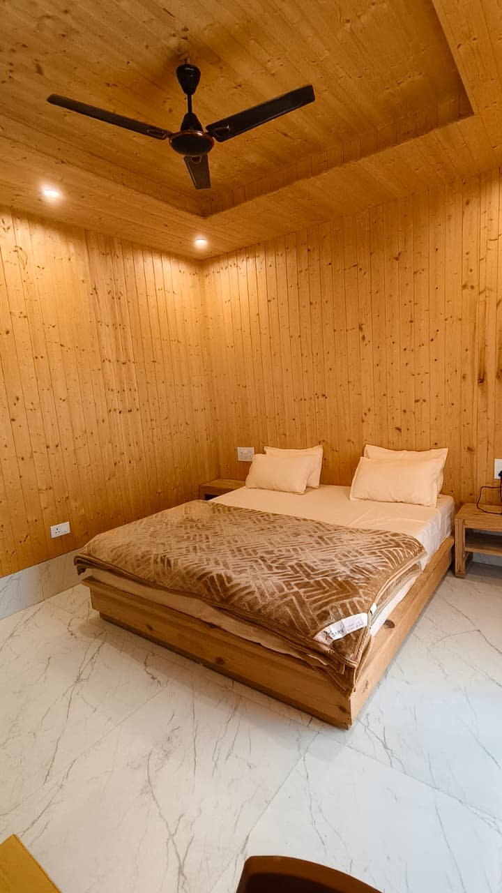 Ganga View Room with panoramic river and mountain vista at Hotel Dhangauri Uttarkashi